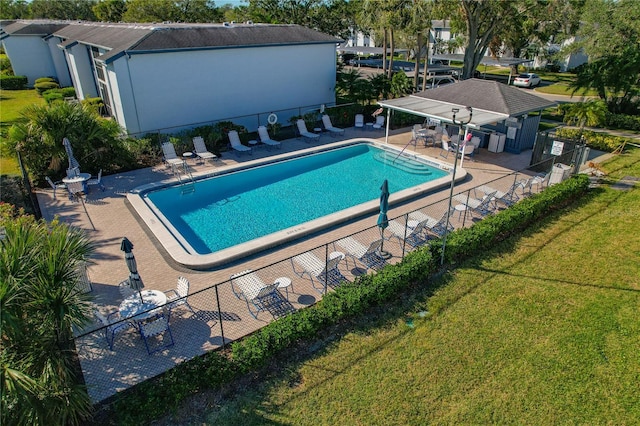 view of pool with a yard and a patio