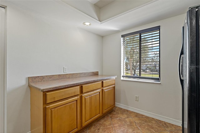 122 E Cypress Ct Unit 22, Oldsmar, FL 34677 - interior space featuring brown cabinetry, light countertops, freestanding refrigerator, and baseboards