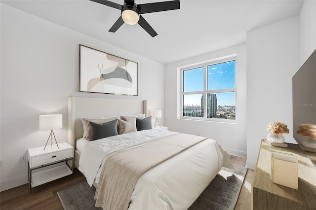 bedroom featuring dark hardwood / wood-style flooring and ceiling fan