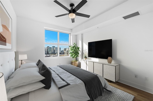 bedroom featuring dark hardwood / wood-style flooring and ceiling fan