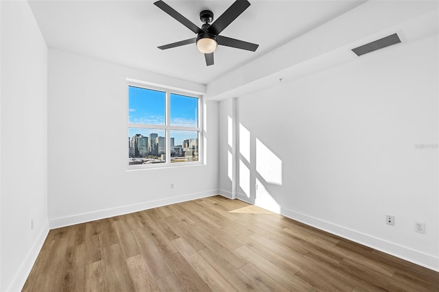 spare room with ceiling fan and light hardwood / wood-style floors