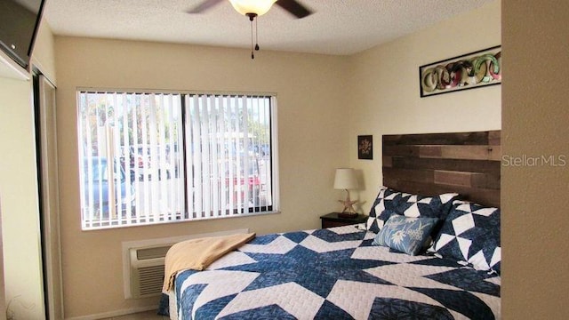 bedroom featuring a textured ceiling, a closet, and ceiling fan