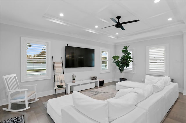 living room with a wealth of natural light, hardwood / wood-style floors, ceiling fan, and crown molding