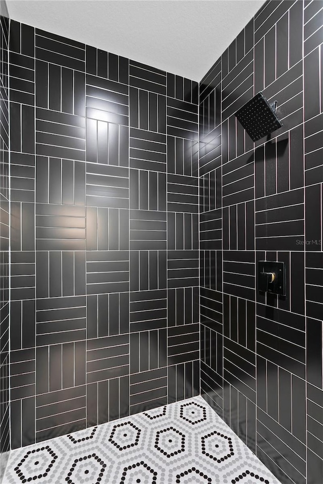 bathroom with a tile shower