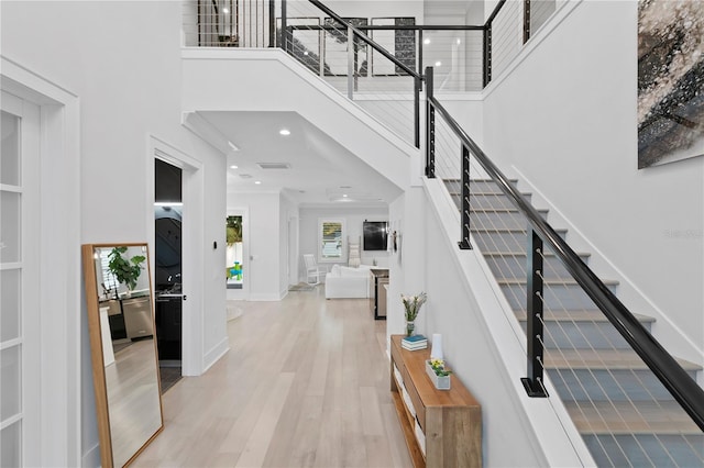 foyer featuring a high ceiling and light hardwood / wood-style flooring