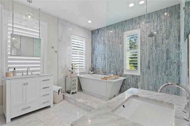 bathroom featuring separate shower and tub and vanity