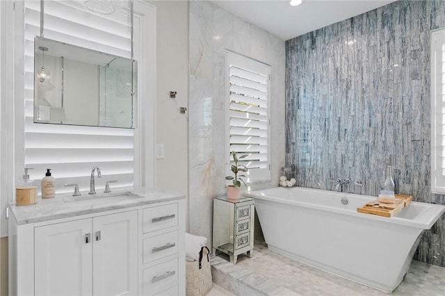 bathroom featuring a tub to relax in and vanity