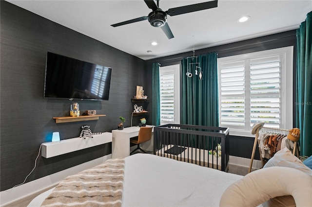 bedroom with ceiling fan and hardwood / wood-style floors