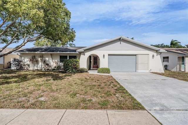 ranch-style house with a garage and a front lawn