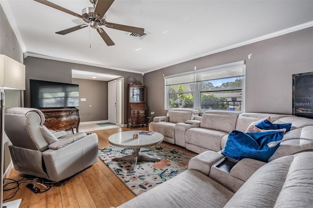 living room with ceiling fan, light hardwood / wood-style floors, and crown molding