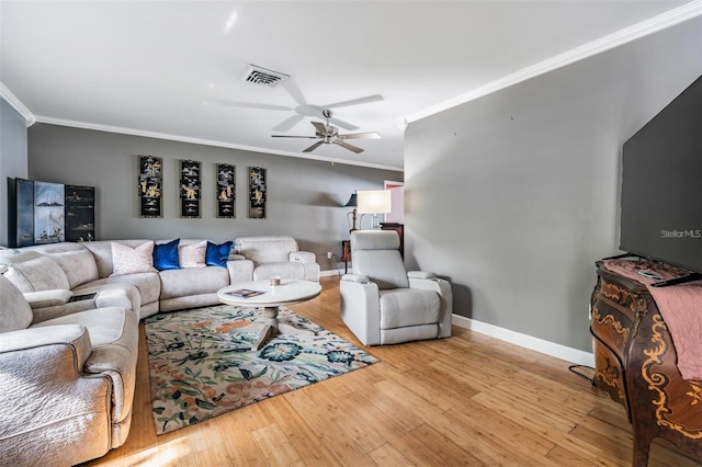 living room with light hardwood / wood-style floors, ceiling fan, and ornamental molding