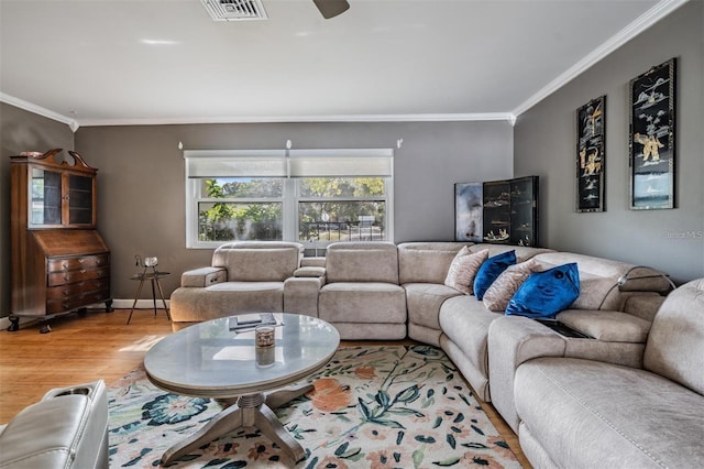 living room featuring ceiling fan, wood-type flooring, and ornamental molding