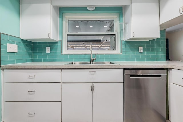 kitchen featuring dishwasher, tasteful backsplash, white cabinetry, and sink