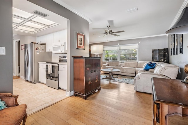 kitchen featuring crown molding, ceiling fan, light wood-type flooring, appliances with stainless steel finishes, and white cabinetry