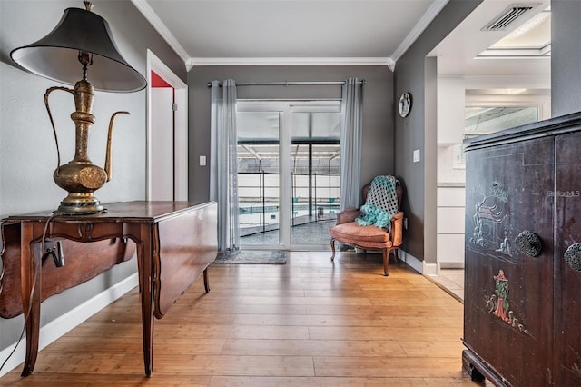 interior space featuring light hardwood / wood-style flooring and crown molding