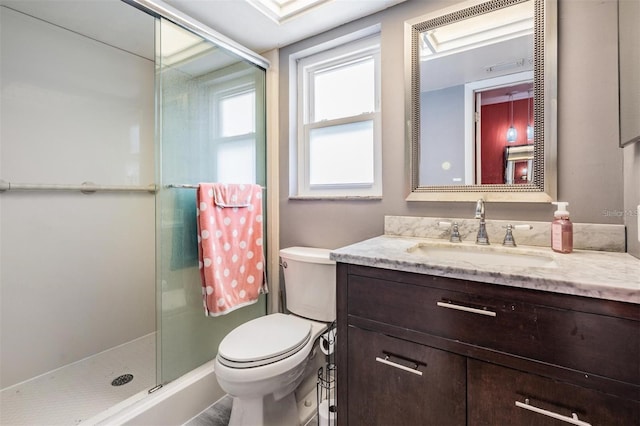 bathroom with an enclosed shower, vanity, and toilet