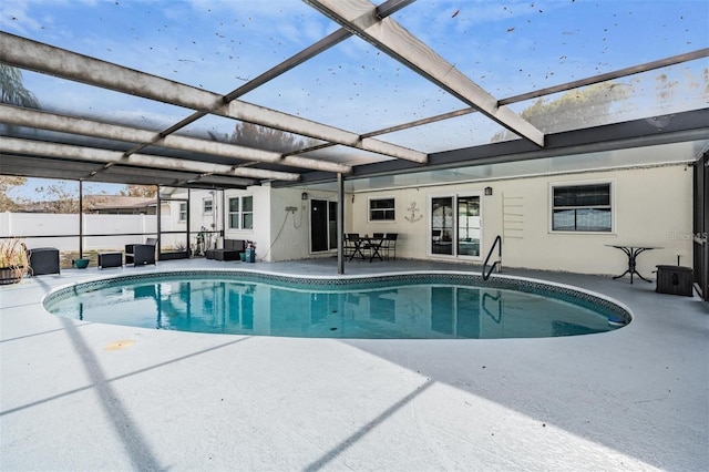 view of pool with a patio area and a lanai