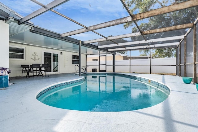 view of pool featuring a patio area and glass enclosure