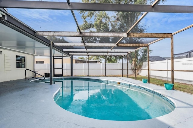 view of pool with a patio area and glass enclosure