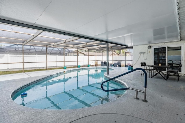 view of swimming pool with a patio area and a lanai