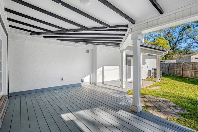 wooden deck featuring central AC and a lawn