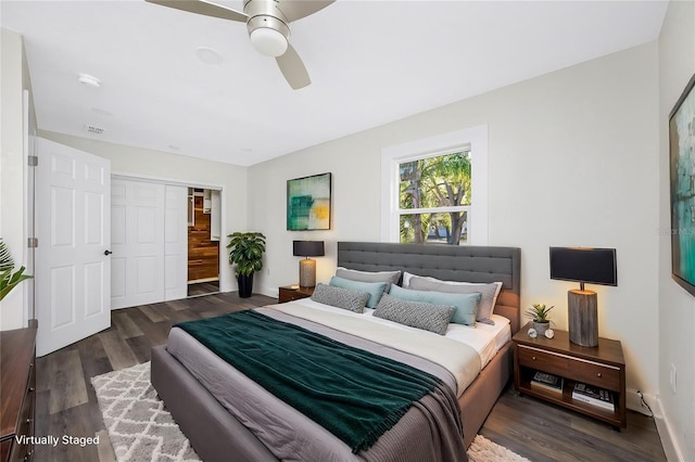 bedroom featuring dark hardwood / wood-style flooring, a closet, and ceiling fan