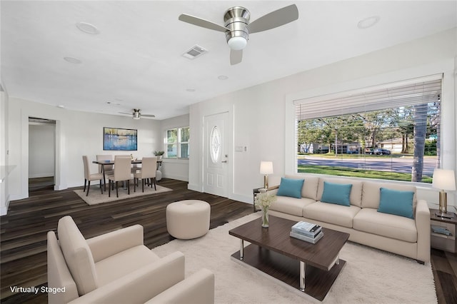 living room with wood-type flooring and ceiling fan