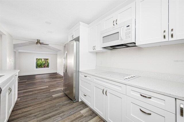 kitchen featuring white appliances, dark hardwood / wood-style floors, light stone countertops, and white cabinets