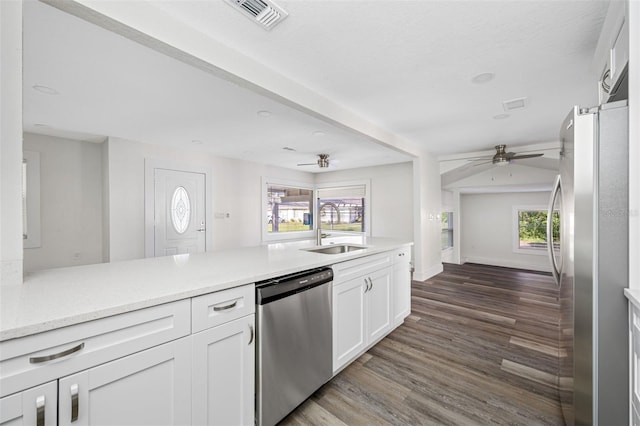 kitchen with sink, white cabinetry, dark hardwood / wood-style floors, ceiling fan, and stainless steel appliances