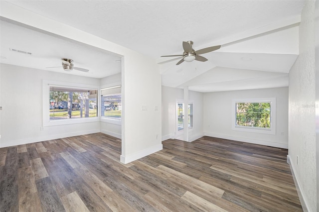 unfurnished living room with ceiling fan, dark hardwood / wood-style flooring, and vaulted ceiling