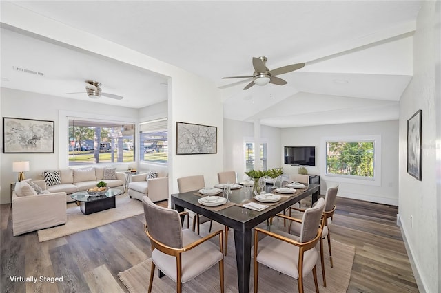 dining area with ceiling fan, lofted ceiling, and dark hardwood / wood-style floors