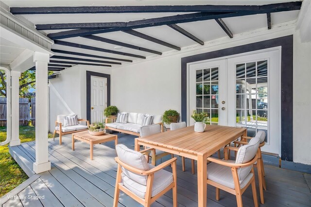 wooden terrace featuring outdoor lounge area and french doors