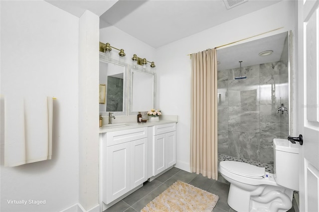 bathroom with a tile shower, vanity, tile patterned flooring, and toilet