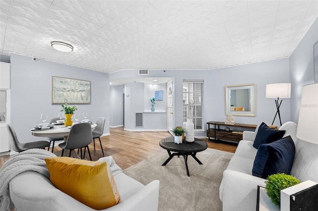 living room with light hardwood / wood-style flooring