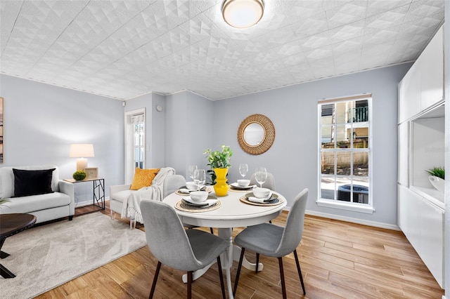 dining space featuring light wood-type flooring