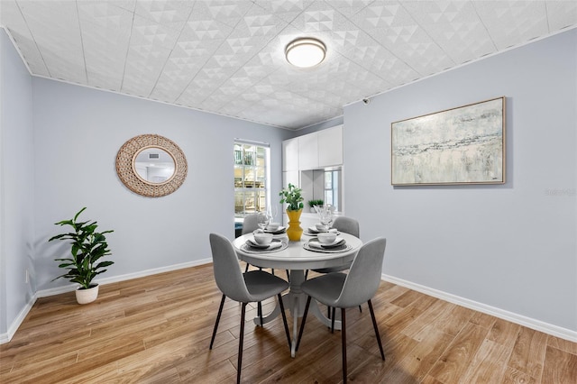 dining space with light wood-type flooring