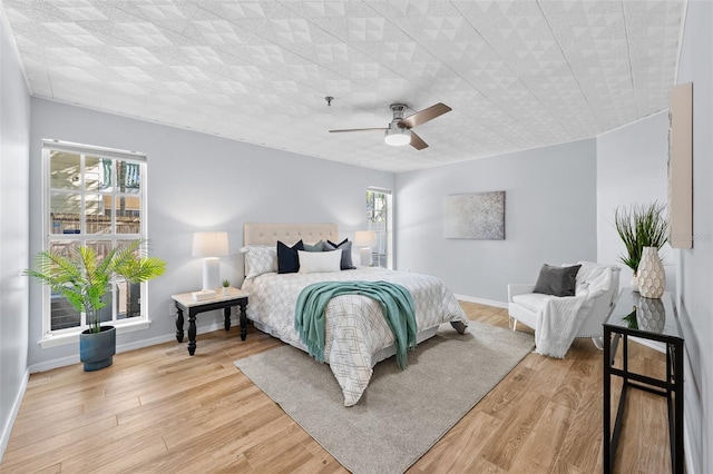 bedroom featuring light hardwood / wood-style floors and ceiling fan