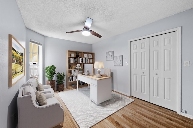 office area with ceiling fan, a textured ceiling, and hardwood / wood-style flooring