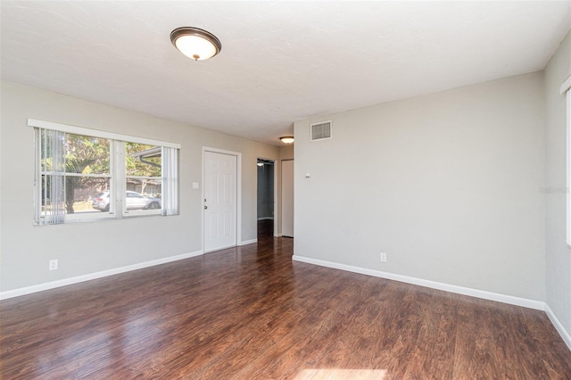 empty room featuring dark hardwood / wood-style floors