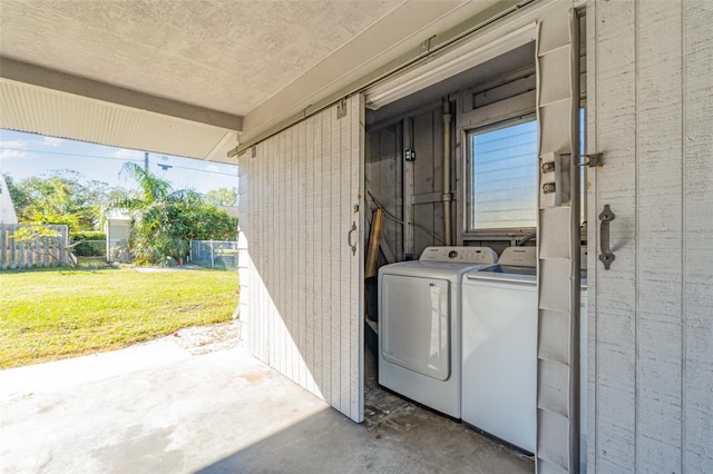 exterior space featuring separate washer and dryer and a lawn