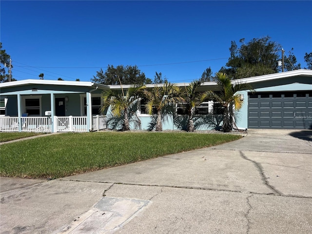 single story home with a porch, a garage, and a front yard