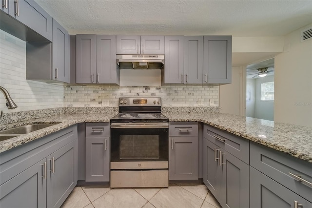 kitchen featuring electric stove, sink, and gray cabinets