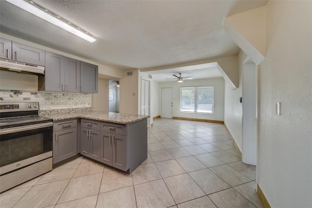 kitchen featuring gray cabinetry, ceiling fan, light stone countertops, tasteful backsplash, and electric stove