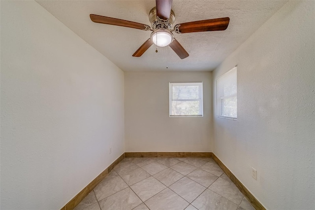 unfurnished room featuring light tile patterned floors, a textured ceiling, and ceiling fan