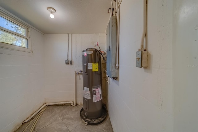 utility room featuring electric panel and electric water heater