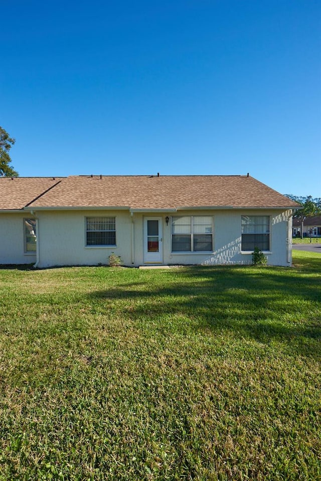 rear view of property with a yard