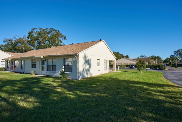 view of side of property with a yard