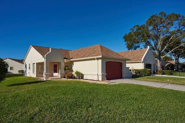 view of front of house featuring a garage and a front lawn