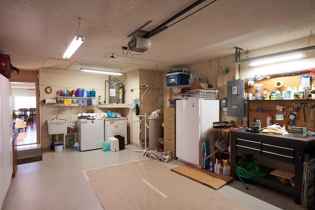 garage featuring a workshop area, water heater, washing machine and dryer, electric panel, and a garage door opener