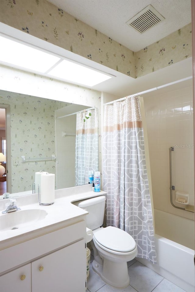 full bathroom featuring tile patterned flooring, vanity, toilet, and shower / bathtub combination with curtain